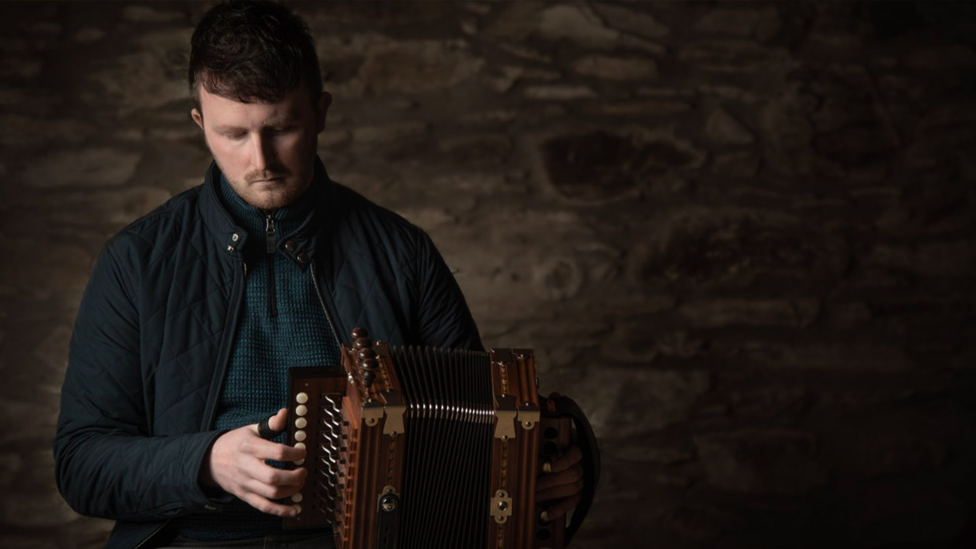 Diarmuid Ó Meachair playing a concertina