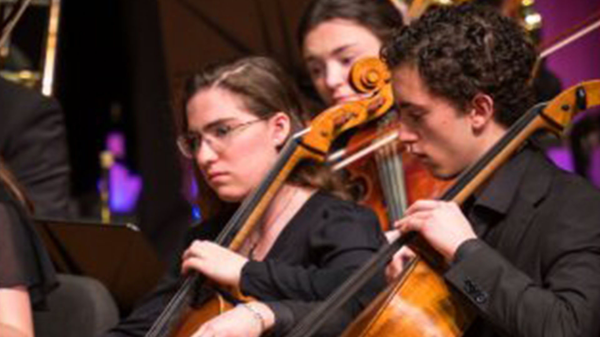 student cellists performing