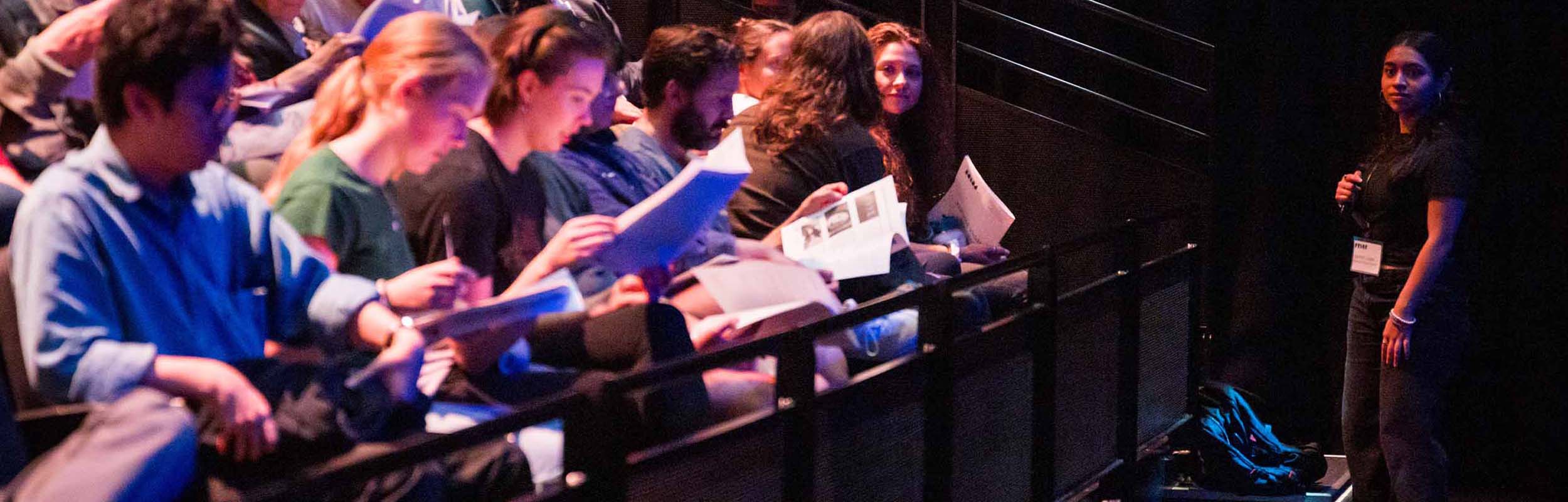 Students gather on stage after a performance