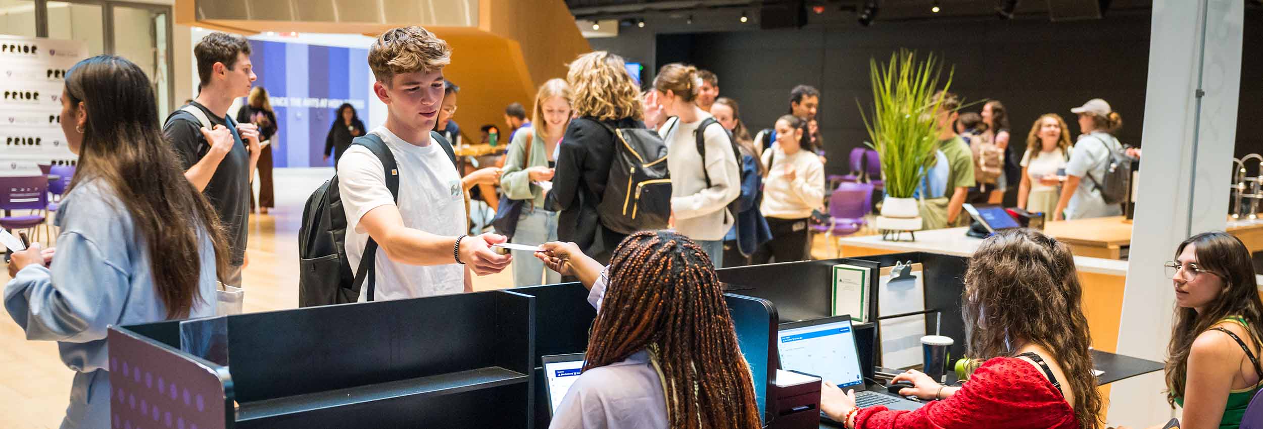 Box Office employees assisting a patron.
