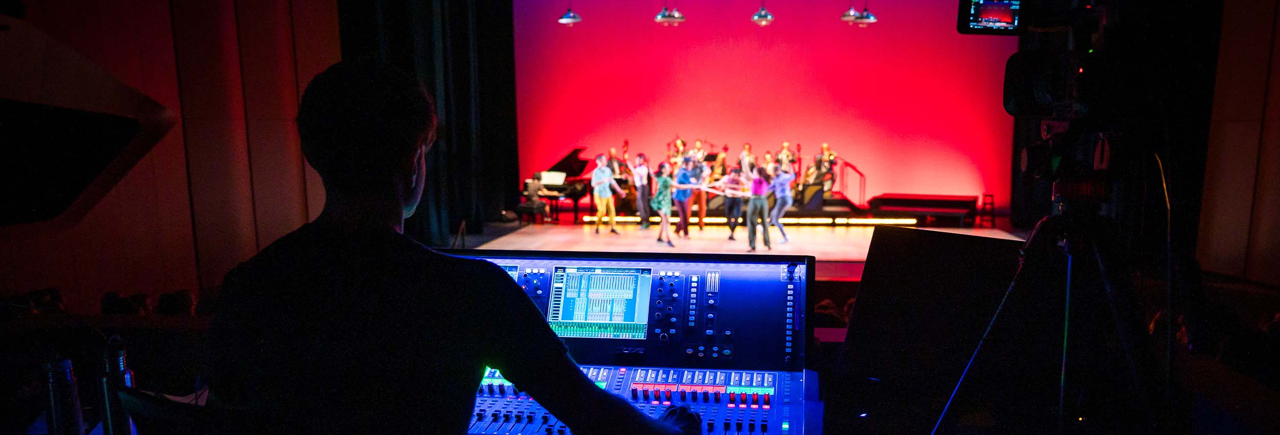 an audio engineer at work during a performance at The Prior