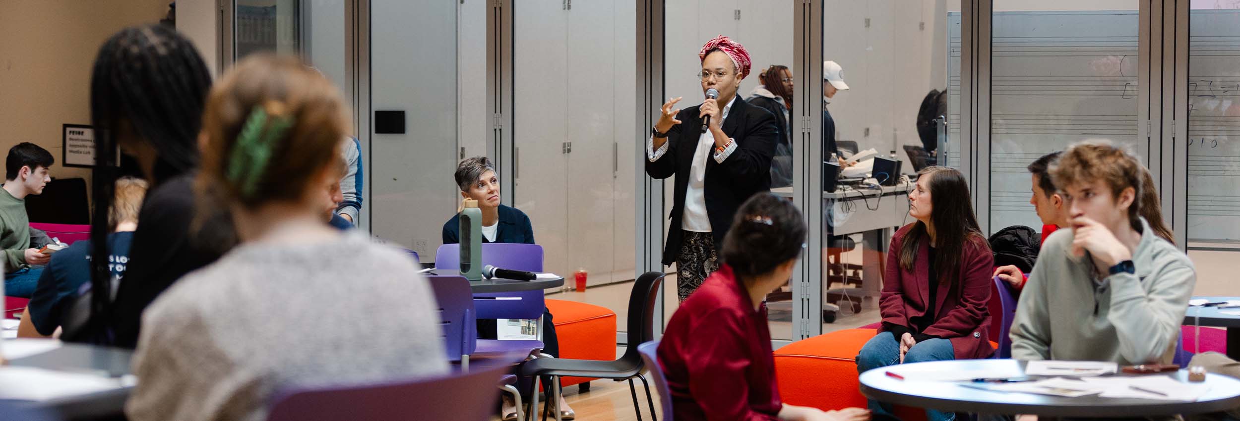 Students and faculty attending a presentation from Jha D Amazi in The Beehive at The Prior.